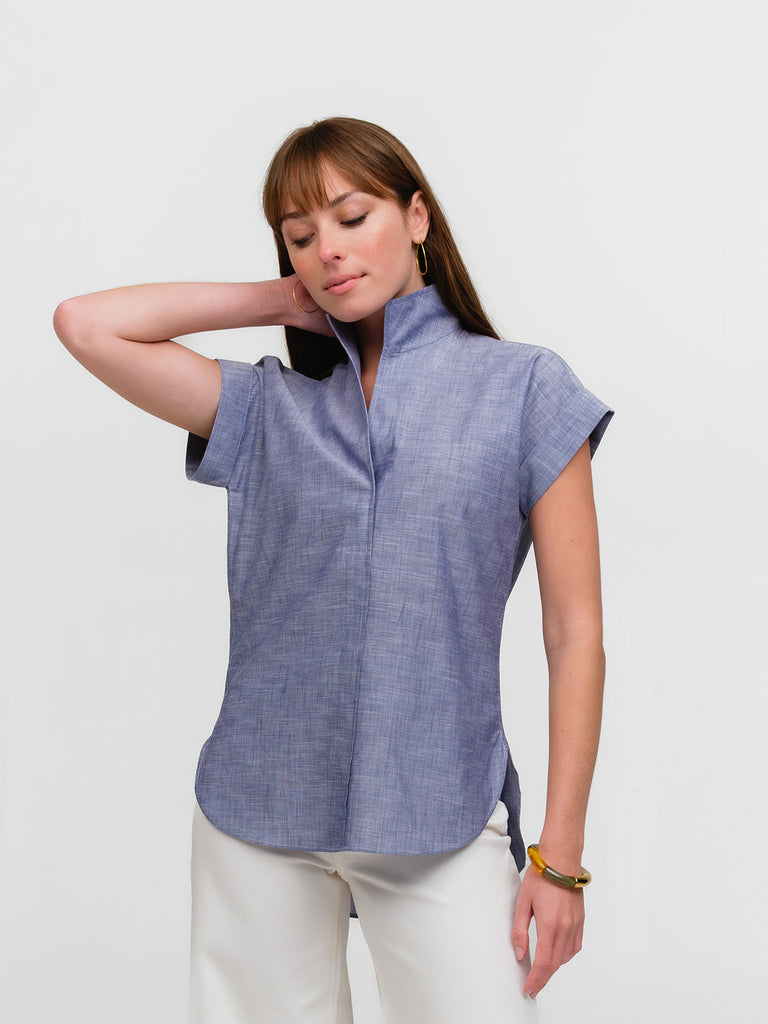 Lady wearing a designer cap sleeve shirt in light blue denim