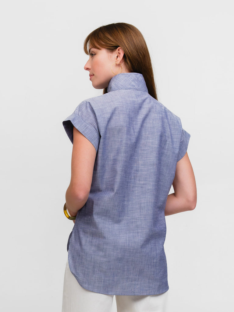 Back of woman wearing a light blue chambray cap sleeve top