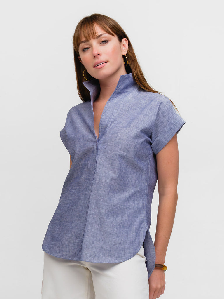 Woman wearing a luxury cap sleeve top in a denim style fabric