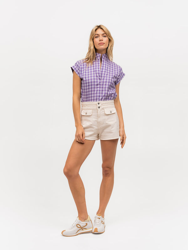 Woman modeling a short sleeve purple gingham top