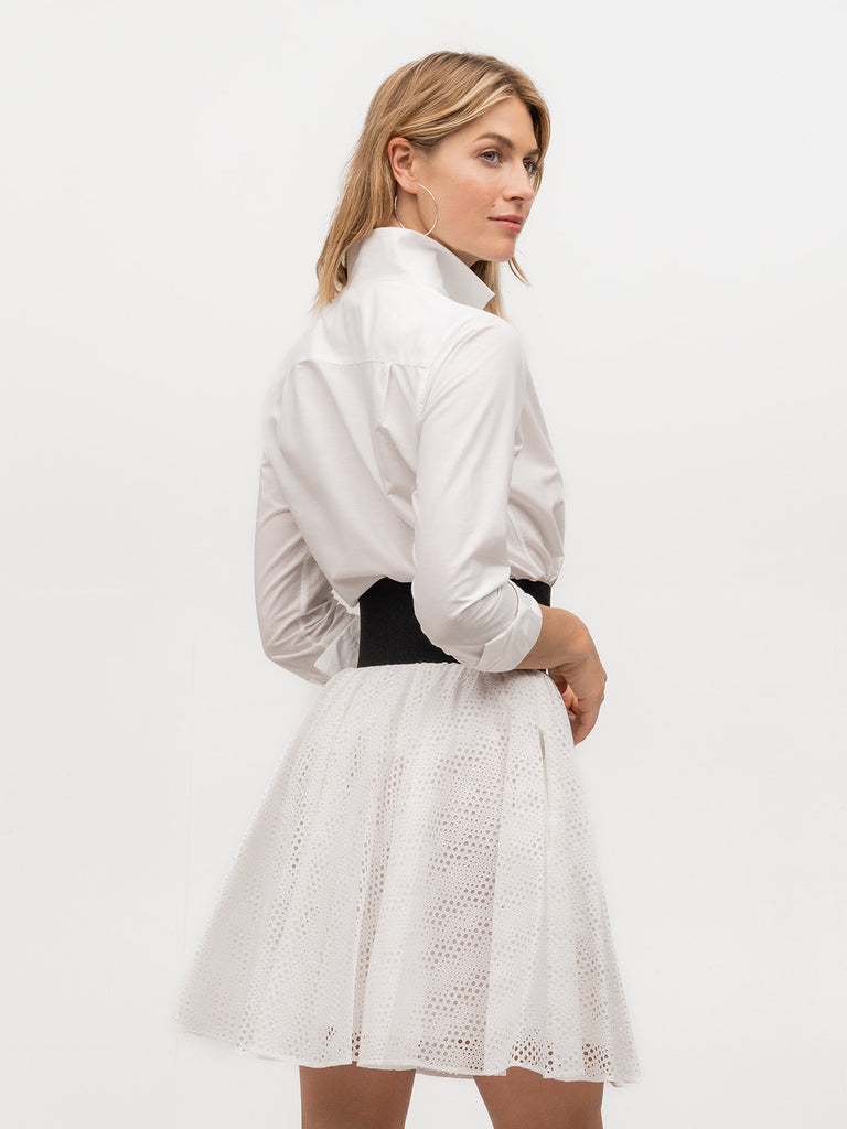 Back of woman wearing an upscale women's dress shirt in white cotton linen fabric