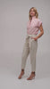 Woman modeling pants with a pink and off white striped cap sleeve top