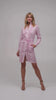 Model wearing a pink and white polka dot designer shirt dress