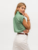 Woman showing back of a green luxury cap sleeve shirt