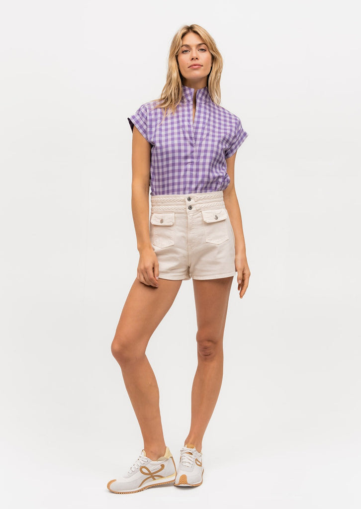 Woman modeling a short sleeve purple gingham top