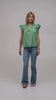 Model wearing a luxury flutter sleeve top in green Italian cotton