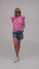 Model wearing a ruffle sleeve shirt in hot pink cotton fabric