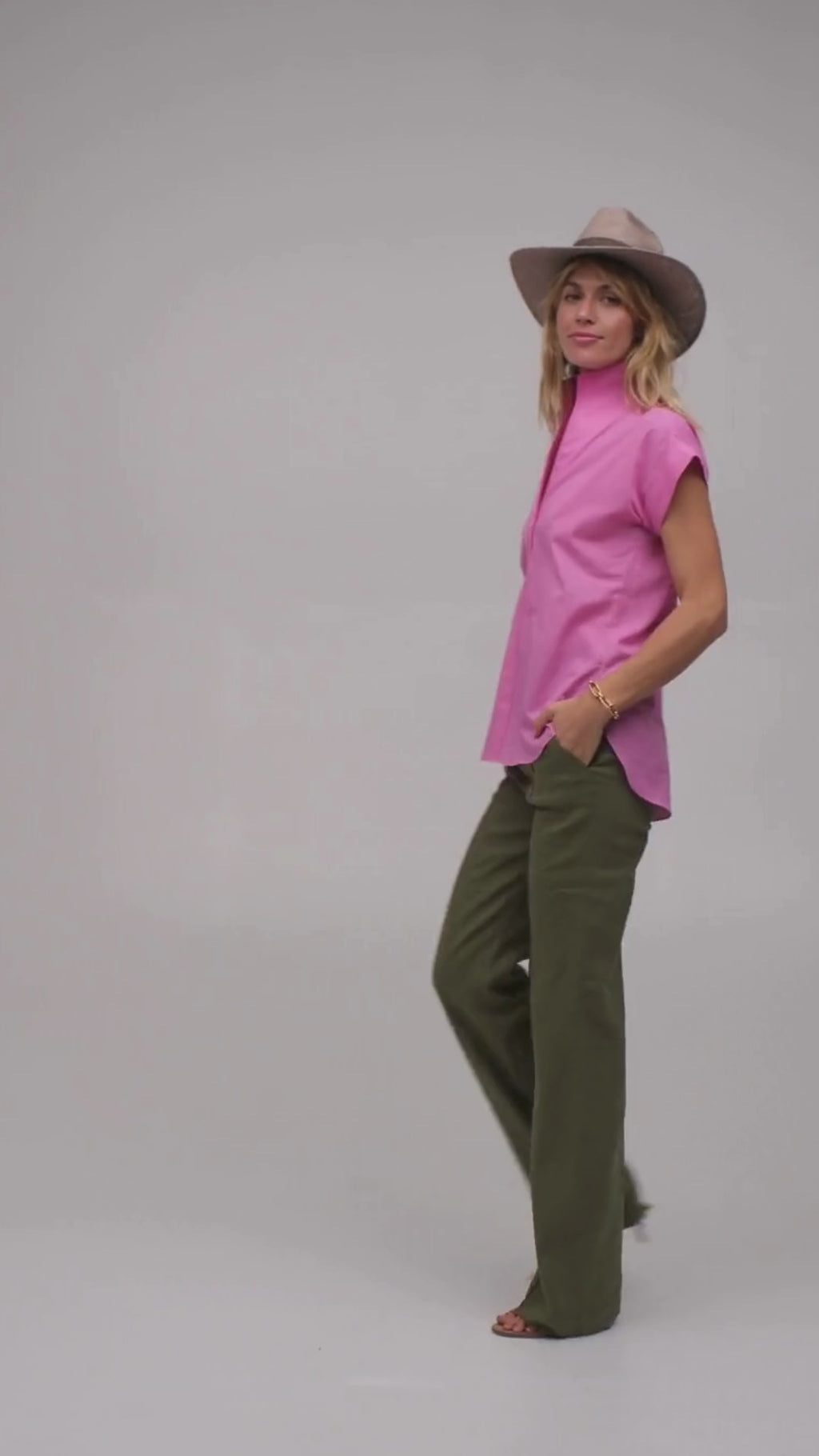 Model wearing a bright pink short sleeve designer shirt