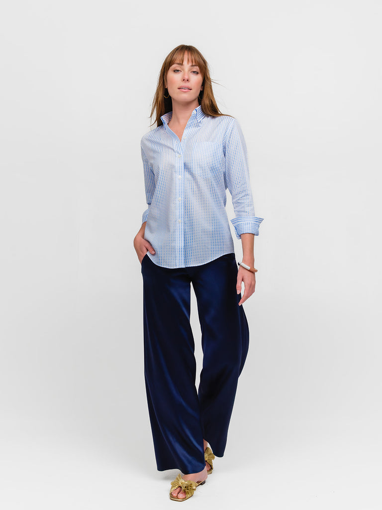 Woman posing while wearing a pale blue polka dot designer button down shirt for women made of fine Italian cotton